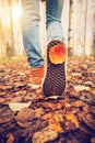 Woman Feet sneakers walking on fall leaves Outdoor