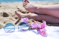 Upside woman feet and red pedicure wear pink sandals, sunglasses at seaside. Funny and happy fashion young woman relax on vacation