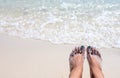 Woman feet on sunny sea beach. Relaxed barefoot tourist by sea. Seaside banner template. Sea water tide