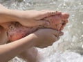 Woman feet in tiny rocks