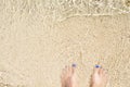 Woman feet on white sand beach. Tropical island seashore. Beach top view photo background Royalty Free Stock Photo