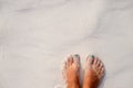 Woman feet and white sand texture. Relaxed tourist on beach. Tropical vacation banner template with text place Royalty Free Stock Photo