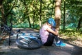 The woman fell from a bicycle in a helmet. Trauma. The concept o Royalty Free Stock Photo