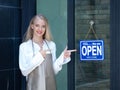 Woman female person blonde hair beautiful pretty open shop store retail shopping happy smile management entrepreneur businesswoman Royalty Free Stock Photo