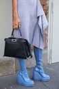 Woman with Fendi dress, boots and black leather bag before Fendi fashion show, Milan Fashion Week