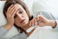 Woman with fever in bed Royalty Free Stock Photo