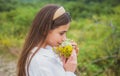 Woman in field. Healthy lifestyle. Carefree girl in meadow with wildflowers.