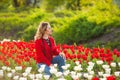 Woman among a field of red and white tulips Royalty Free Stock Photo