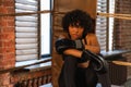 Woman fighter girl power. African american woman fighter with boxing gloves sitting on boxing ring waiting and resting Royalty Free Stock Photo