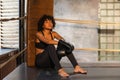 Woman fighter girl power. African american woman fighter with boxing gloves sitting on boxing ring waiting and resting Royalty Free Stock Photo