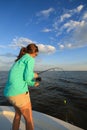 Woman Fighting Fish Saltwater Fishing With Rod and Reel