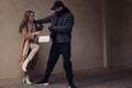 Woman fighting with thief while he trying to steal her bag outdoors, space for text. Self defense concept Royalty Free Stock Photo