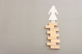 Woman figure standing on stack of domino blocks. Concept of risk, success, and problem solving Royalty Free Stock Photo