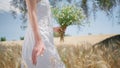 Woman figure walking spikelets field closeup. Happy rural lady sniffing bouquet Royalty Free Stock Photo