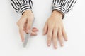 Woman filing damaged nails. Fingernails with onycholysis after removing gel polish