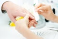 Woman filing fingernails of a man in nail parlor Royalty Free Stock Photo