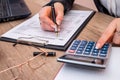 Woman filing individual income tax form 1040, with calculator Royalty Free Stock Photo