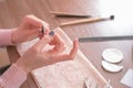 Woman filings nails nail file. Close-up hands. Tools on the table. Royalty Free Stock Photo