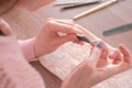 Woman filings nails nail file. Close-up hands. Tools on the table. Royalty Free Stock Photo
