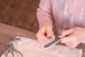 Woman filings nails nail file. Close-up hands. Tools on the table. Royalty Free Stock Photo