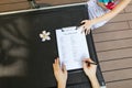 Woman fill visa application in travel agency. close up hands, pe