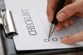 Woman filling Checklist at table, closeup view Royalty Free Stock Photo