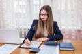 Woman filling 1040 form, work in office