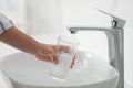 Woman filling glass with water from faucet over sink, closeup Royalty Free Stock Photo