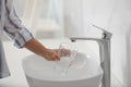 Woman filling glass with water from faucet over sink, closeup Royalty Free Stock Photo