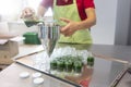 Woman filling wheatgrass smoothie in glasses Royalty Free Stock Photo