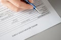 Woman filling hotel reservation form putting first name. Reception desk. Hotel service, registration. Close up. Selective focus.