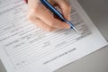 Woman filling hotel reservation form putting first name. Reception desk. Hotel service, registration. Close up. Selective focus.