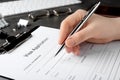 Woman filling visa application form for immigration at grey table, closeup Royalty Free Stock Photo