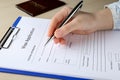 Woman filling visa application form for immigration at table, closeup Royalty Free Stock Photo