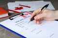 Woman filling visa application form to Canada at table Royalty Free Stock Photo