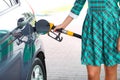 Woman fills petrol into the car at a gas station Royalty Free Stock Photo