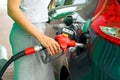 Woman fills petrol into the car at a gas station Royalty Free Stock Photo