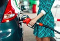 Woman fills petrol into the car at a gas station Royalty Free Stock Photo