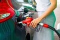 Woman fills petrol into the car at a gas station Royalty Free Stock Photo