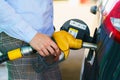 Woman fills petrol into the car at a gas station Royalty Free Stock Photo