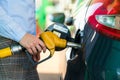 Woman fills petrol into the car at a gas station Royalty Free Stock Photo