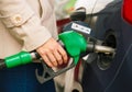 Woman fills petrol into her car at a gas station Royalty Free Stock Photo