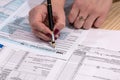 woman fills in the tax form 1040