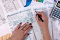 A woman fills in the tax form 1040