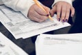 Woman fills the tax form, working with tax documents. Form 1040 Individual Income Tax return form. United States Tax forms.