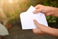 Woman fills the white paper mock up into the envelope mail