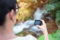 Woman filming nature with action camera concept