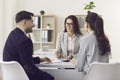 Woman financial advisor giving consultation to family couple about buying house