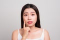 Woman finding an acne on her forehead. Portrait of a woman watch Royalty Free Stock Photo