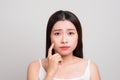 Woman finding an acne on her forehead. Portrait of a woman watch Royalty Free Stock Photo